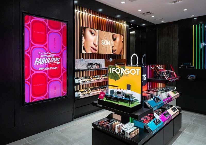 A cosmetics store interior with glowing promotional displays and product shelves